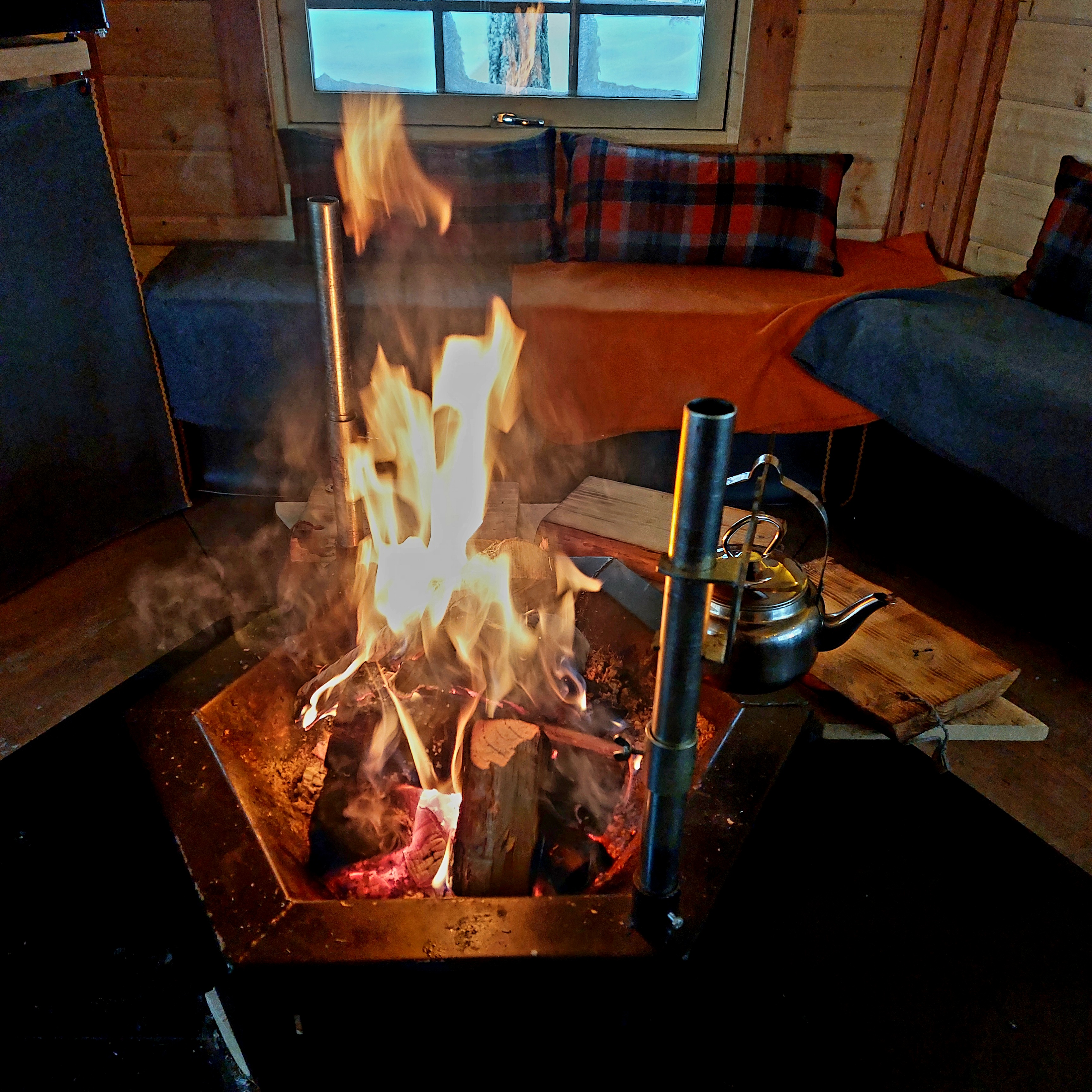Inside the Lappish kota with an open fire and reindeer hides